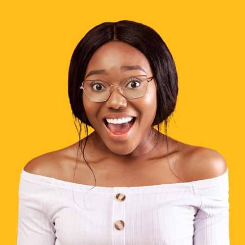 Opened mouthed teen girl with glasses, white shirt and yellow background.